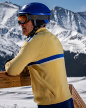 Load image into Gallery viewer, man wearing yellow merino wool ski sweater after skiing 
